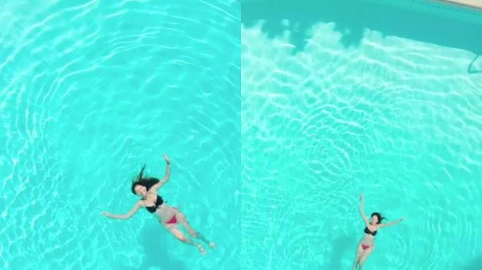 游泳池中穿着比基尼的美丽西班牙裔妇女的垂直镜头