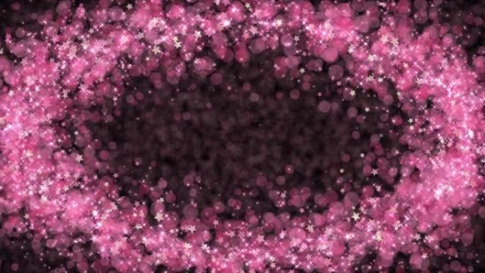 黑色背景上漂浮椭圆形的闪亮粉色颗粒
