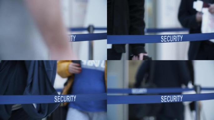 机场蓝色磁带屏障上的安全文本。登机前排队等待海关检查的人