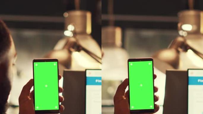 垂直视频: 启动员工手持带绿屏的智能手机