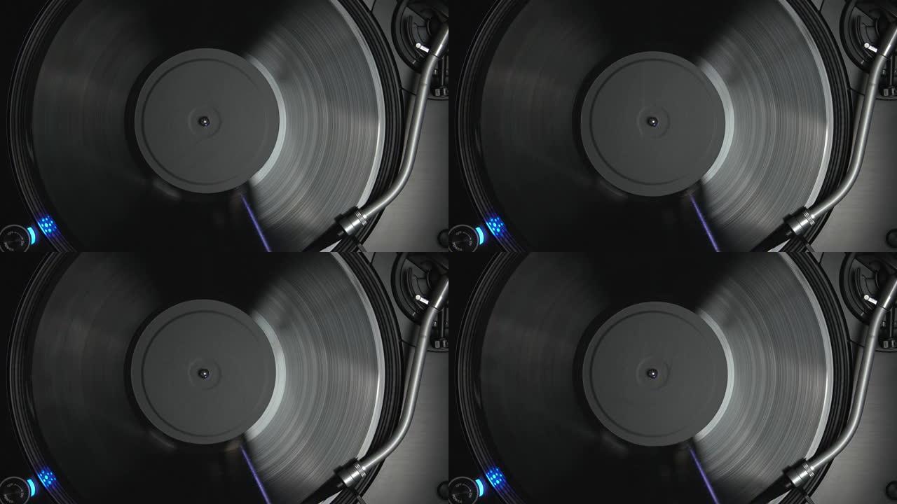 DJ转盘播放模拟唱片。转盘针在旋转乙烯基光盘与音乐。从4k上方拍摄的唱片骑师音频设备