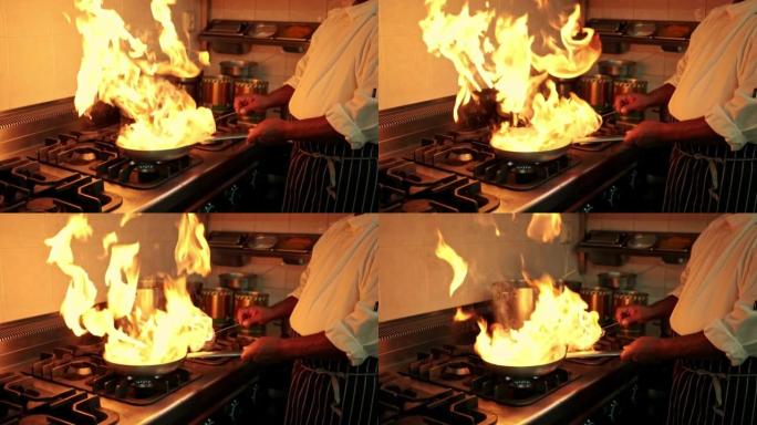 专业厨师在燃气灶上的锅中flamb é ing