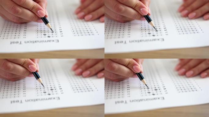 女人手握铅笔并标记测试答案
