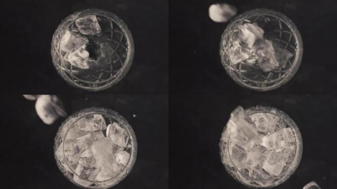 冰块落空玻璃特写。清凉饮料制备概念