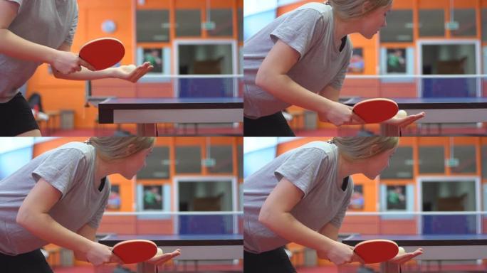 女子乒乓球或乒乓球运动员的特写镜头，慢动作