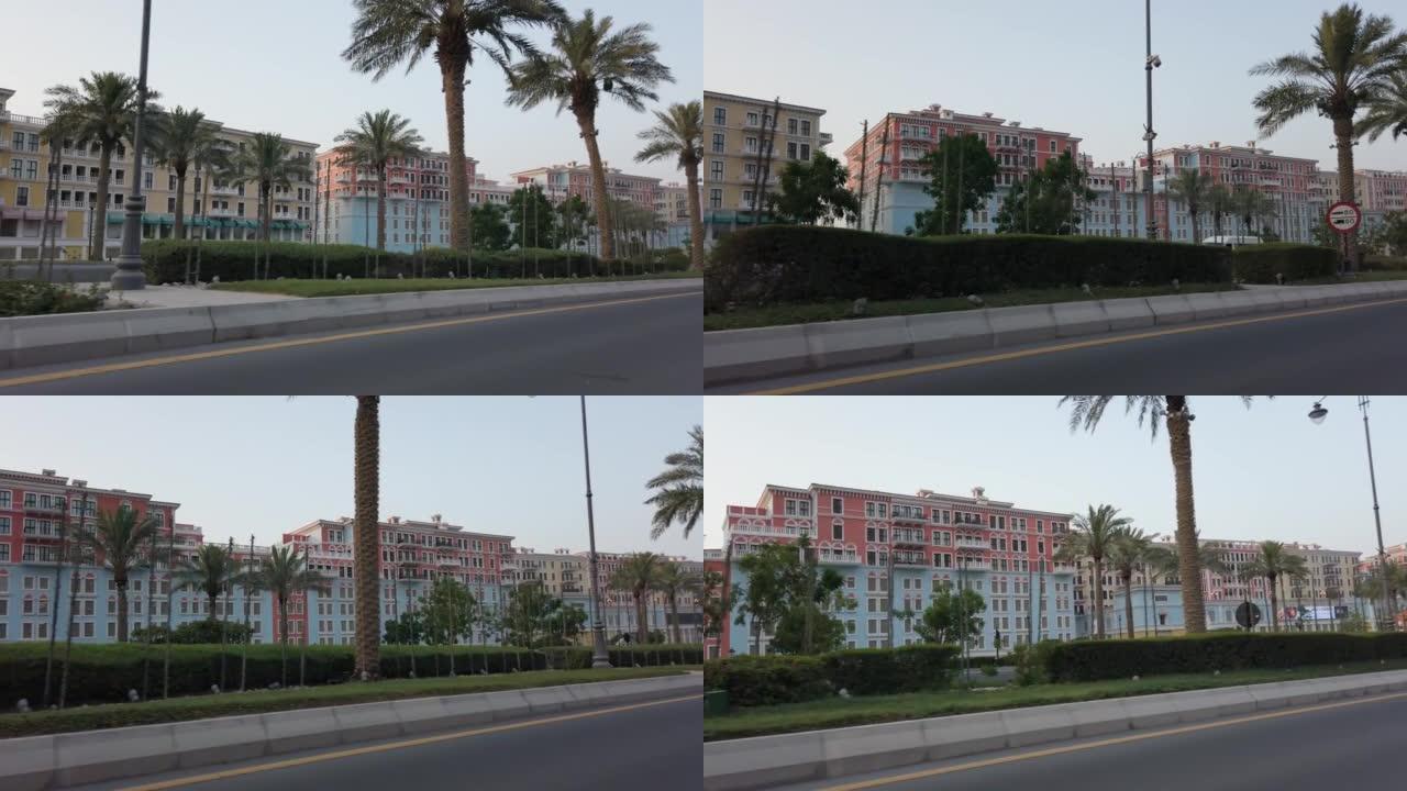在卡塔尔珍珠区Qanat Quartier的棕榈树上行驶pov，这是多哈威尼斯的复制品