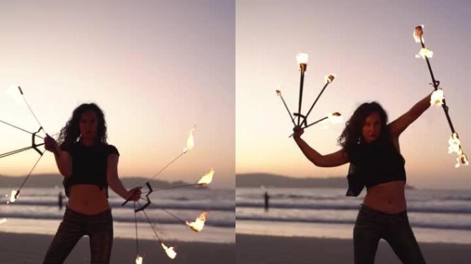 拉丁年轻女子晚上在海滩上用火表演