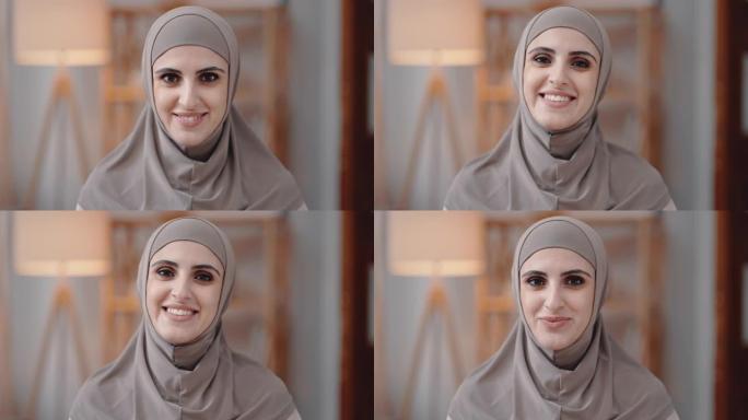 戴着头巾的阿拉伯女人，脸上表情满意