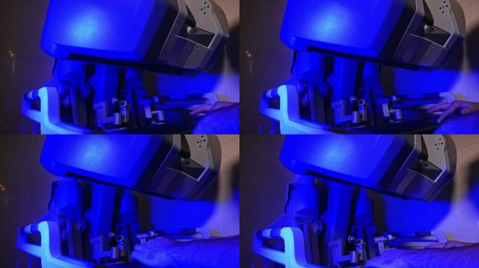 机器人设备技术装置的上部上升。达芬奇机器人在手术室的蓝光下开始工作。
