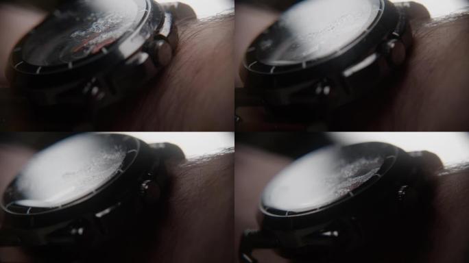 带有水颗粒的模糊手表的极端特写，戴在手臂上，背景概念
