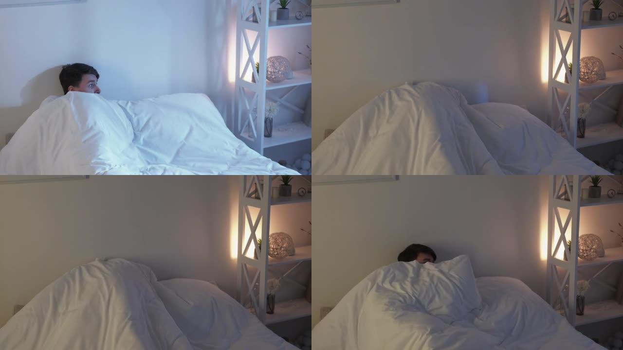 床上恐惧不眠夜的家伙躲在毯子下