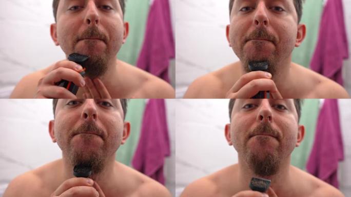每天早上在浴室里做英俊的男人，在镜子前用电动修剪器去除面部毛发，年轻成年人的皮肤护理程序。男性美容和