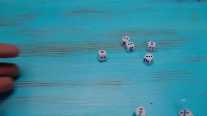 在蓝色的木制运动场上掷骰子。运气和兴奋。概念棋盘游戏策略。选择性聚焦