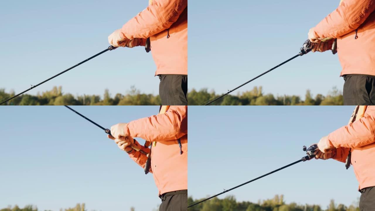 一名男子在抓鱼时在旋转杆上旋转卷轴。