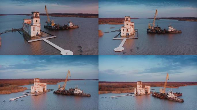 修复岛上沉没的灯塔。码头的破冰船。操作起重机，从驳船上重新装载沙子。空中无人机拍摄的