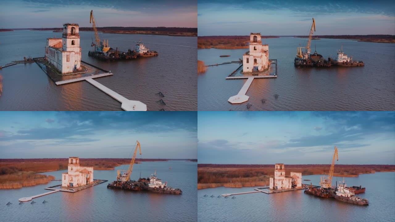 修复岛上沉没的灯塔。码头的破冰船。操作起重机，从驳船上重新装载沙子。空中无人机拍摄的