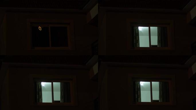 黑暗的傍晚时分，房子的窗户发出了光。房间亮起，然后关闭。
