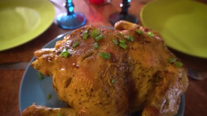 感恩节食物。烤鸡用葱装饰，火鸡放在桌子上。鲜肉。特写