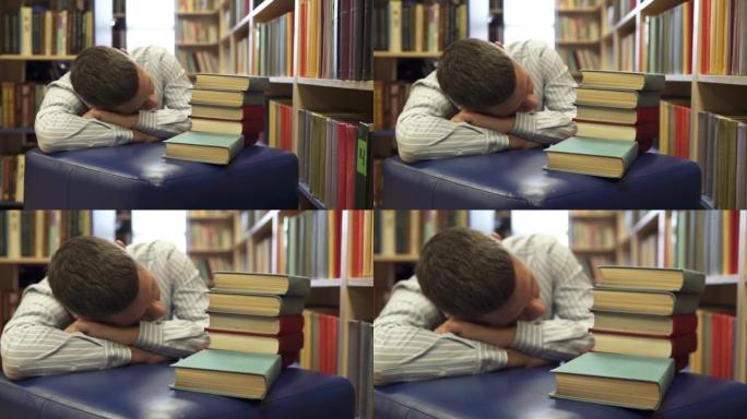 学生在准备考试的一排排书架之间睡着了。大学图书馆