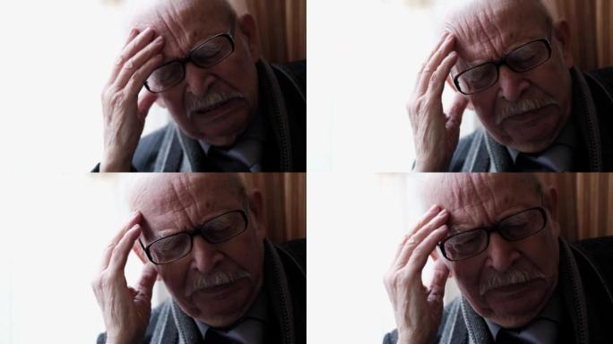 特写老人头痛的祖父肖像，在家中的高级养老金领取者。沮丧的人。