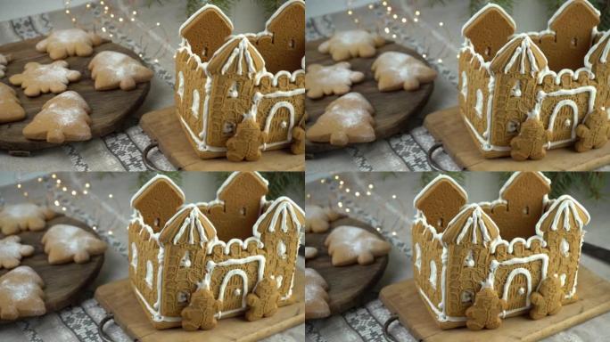 姜饼屋圣诞自制烘焙。姜饼人。圣诞树形状的饼干和桌子上的雪花。甜点的食物。冬季姜饼。