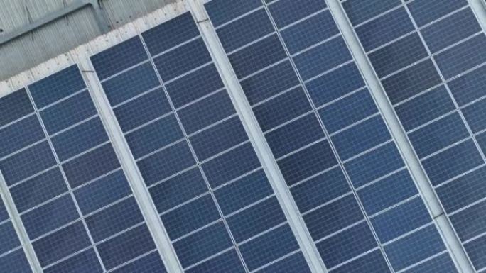 缩小工业厂房屋顶上的太阳能电池板。用于工厂或仓库建筑的太阳能。商用太阳能。工业光伏板。屋顶太阳能。可