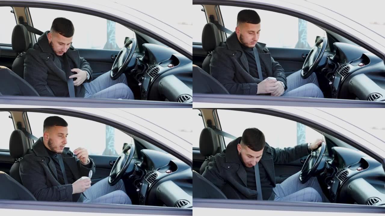 一个年轻的英俊男子正在准备乘车并系好安全带并通过电话与某人交谈。