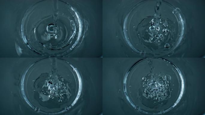 纯净水填充玻璃俯视图特写。水晶透明液流鼓泡