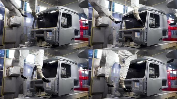 汽车车架涂装工艺的工业背景。景。在生产汽车时使用喷漆机器人的车间内部查看。