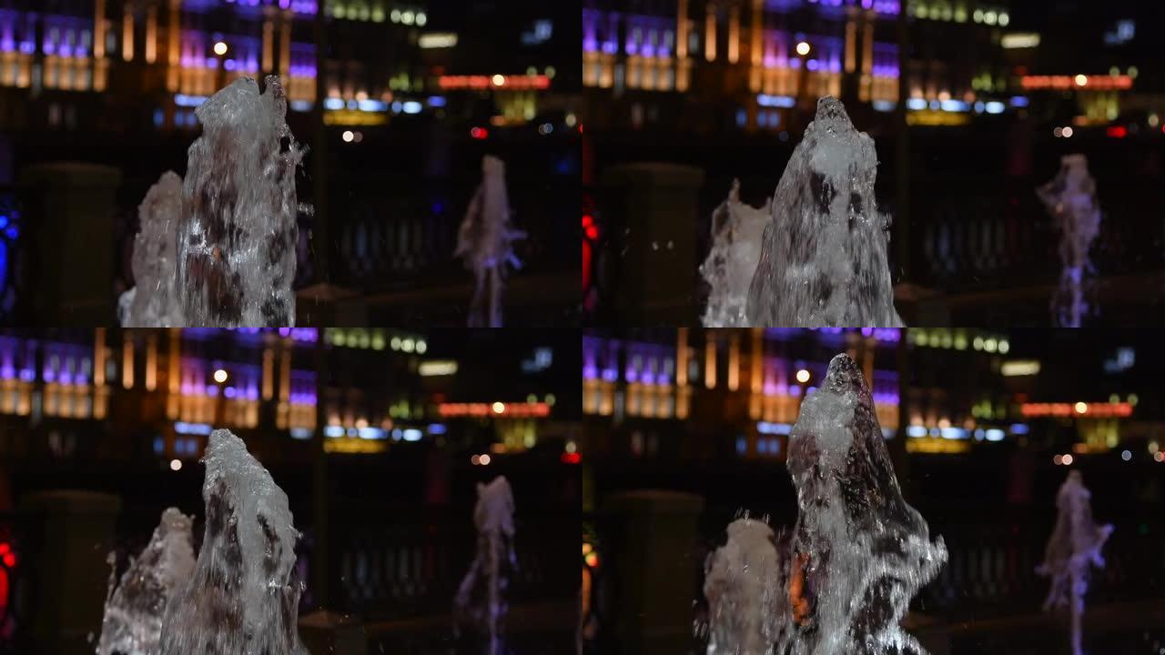 夜间城市喷泉的喷水