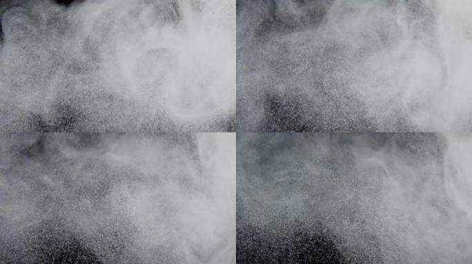 灰尘，面粉，碎屑的颗粒，在黑色背景上飞行。白色粉末，雪，片状穿过太空。