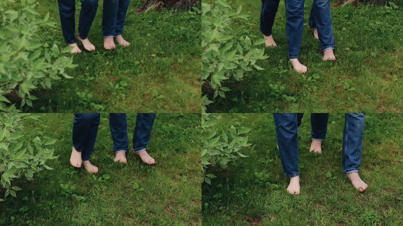 赤脚走在草地上的恋人的脚。相机以慢动作拍摄特写