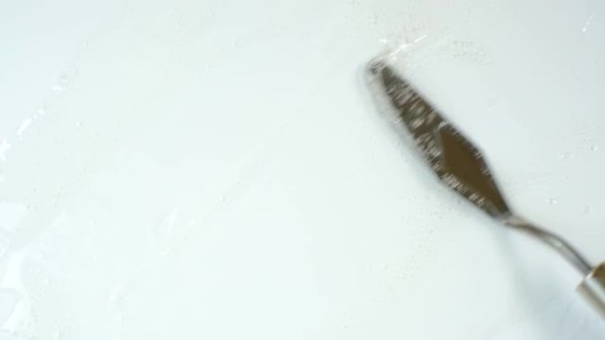 使用抹刀在白色背景上涂抹保湿沐浴露。
