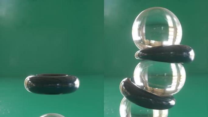 橡胶球和环堆在绿色上。令人满意的3d动画。垂直方向