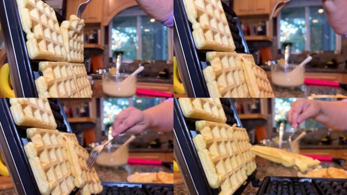 维也纳比利时华夫饼波纹。在电华夫饼熨斗中烘烤的过程。烹饪。在华夫饼干模具中烹饪华夫饼干煎饼，将液体面