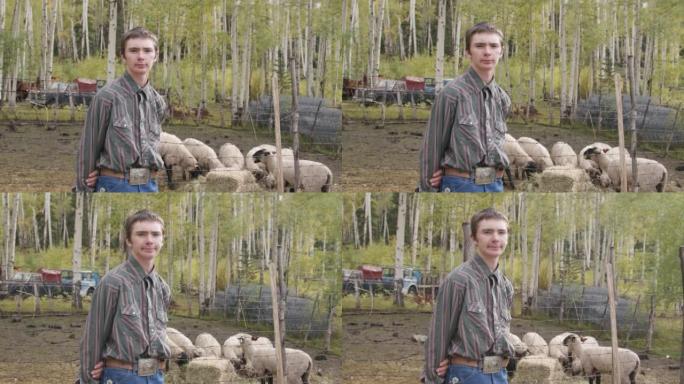 美国科罗拉多州一个小镇家族牧场上，一名英俊的男性高加索牧场主少年和他的羊站在一起，看着相机的视频肖像