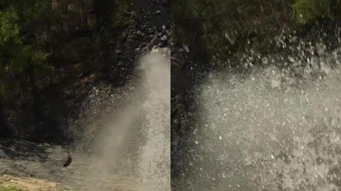 垂直拍摄瀑布，无人机在水花之间潜水