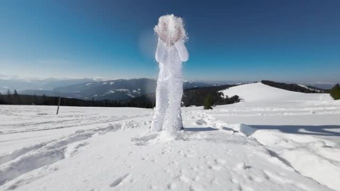 穿着白色衣服的女人在阳光明媚的冬日里下雪