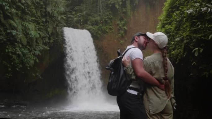 男女夫妇在印度尼西亚巴厘岛巴图尔山的隐藏瀑布接吻