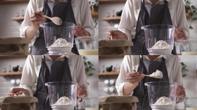 在厨房秤上称量面粉的过程，制作面团的正确配方厨具