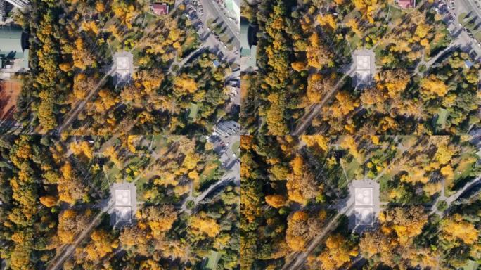 摩尔多瓦基希讷乌一个广场的空中无人机视图。公园有泛黄的树木和运动场，垂直视图