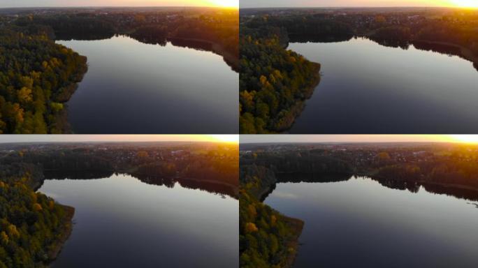 碧蓝的大湖的史诗般的俯视图。夕阳下清湖天空的倒影。池塘早晨日出。空中无人机视图秋天五颜六色的树木。鸟