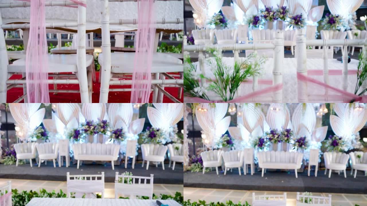 美丽的婚礼装饰充满鲜花。为akad nikah婚礼穆斯林装饰的婚礼椅子，新郎，新娘的父亲和两名证人将
