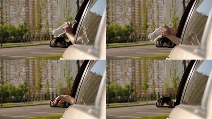 一个女人从车窗里扔一个塑料瓶的特写镜头。