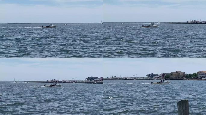 小渔船在巴比伦长岛海岸的大南湾检查螃蟹陷阱