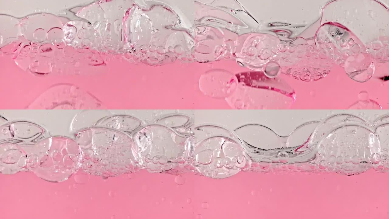 运动的油的缓慢运动，水中的气泡在浅白色背景上上升。带有气泡的透明化妆品凝胶液。宏观拍摄。特写