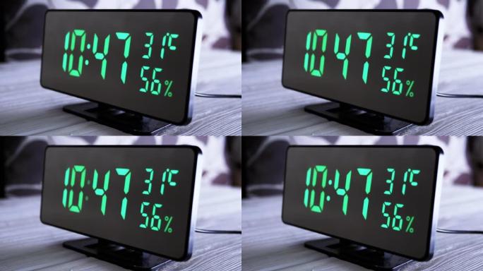 数字时钟在绿色显示上午10:47上显示时间、温度、空气湿度
