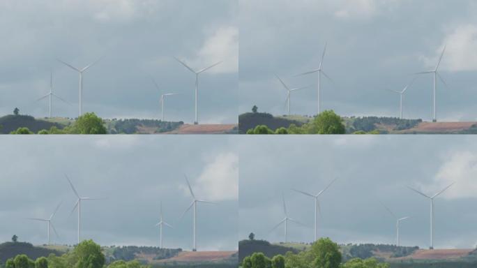 风力涡轮机在山上、白天的天空、可再生和清洁能源上发电。减少碳排放为未来的概念，拍摄距离很远。