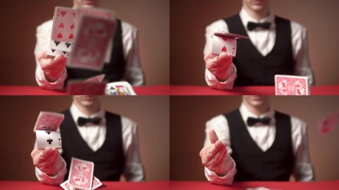 年轻的男性副主持人在玩红色的桌子上散射卡片。特写
