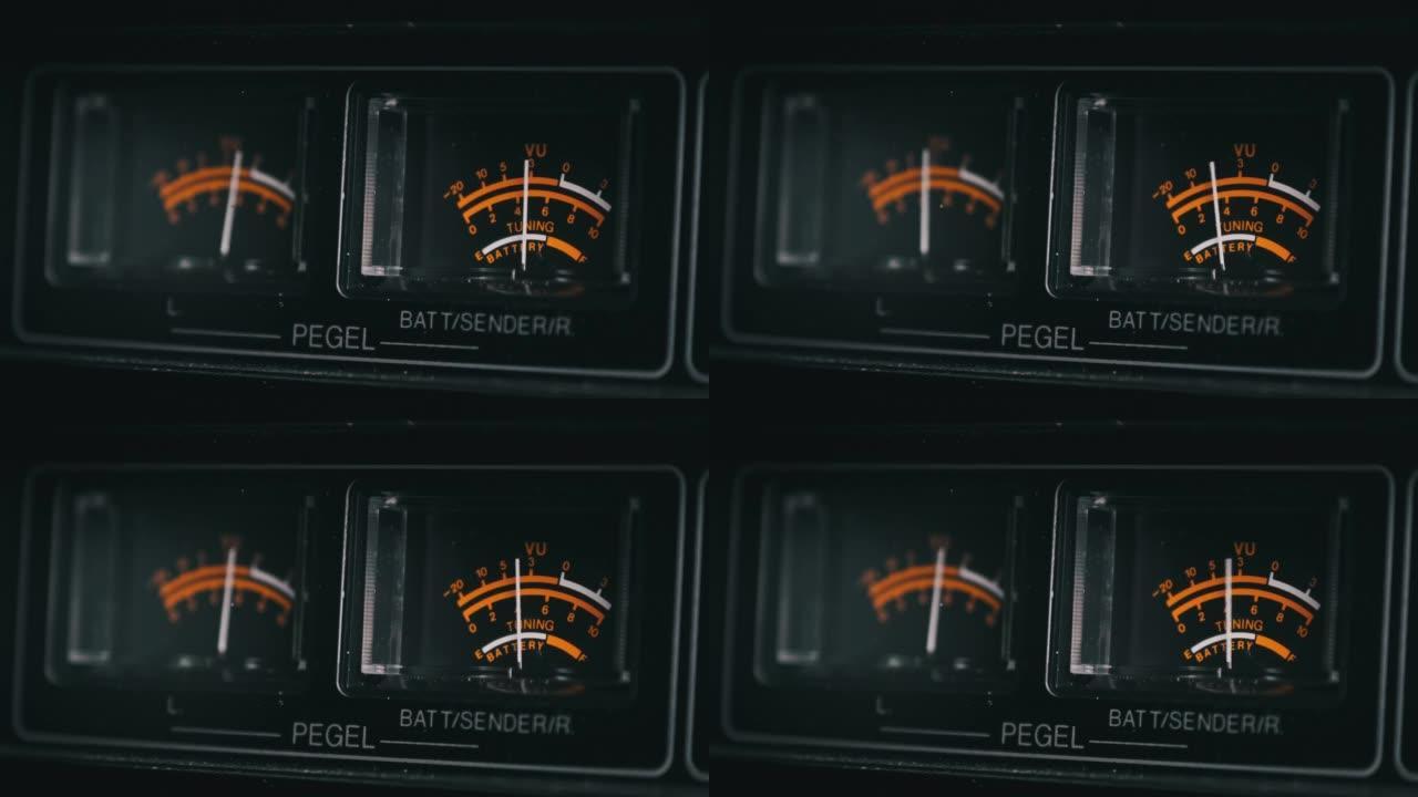 黑色立体声录音机上的模拟VU仪表，箭头指示器